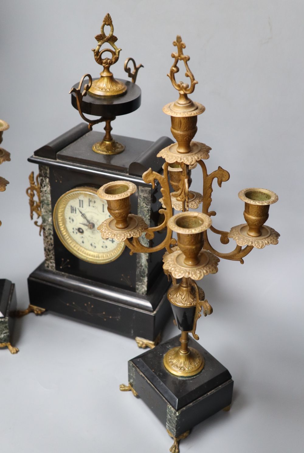 A 19th century black slate clock garniture